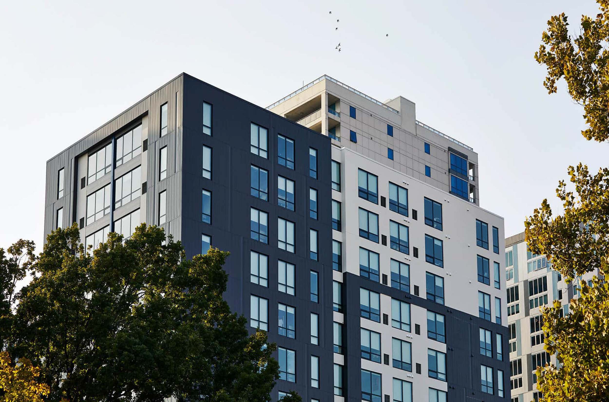 Upwards shot of modern black and white apartment buildings